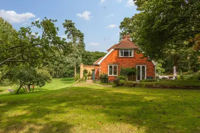 a red brick house on a green lawn at Briar Hill in Aldringham