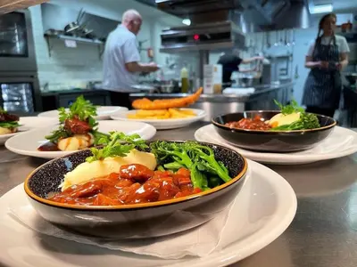 a table with bowls of food on plates in a kitchen at Bedingfeld Arms in Swaffham