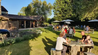 a group of people sitting at a table in a yard at Bedingfeld Arms in Swaffham