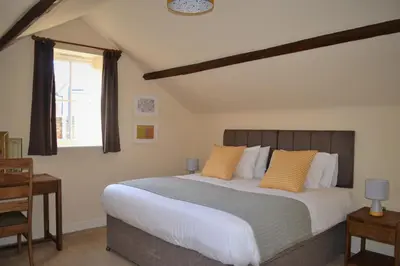 a bedroom with a large bed with yellow pillows at The Old Bottle Store - 2 Double Bedrooms, 2 Bathrooms, St Ives, Cambridgeshire in St Ives