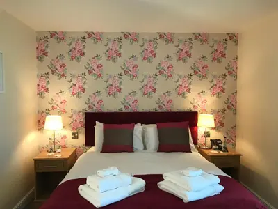 a bedroom with a bed with two towels on it at The Bird in Hand in Ashwellthorpe