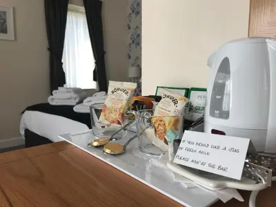 a table with a tray of food and a sign on it at The Bird in Hand in Ashwellthorpe