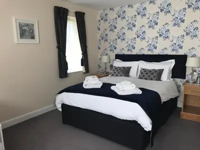 a bedroom with a bed with two towels on it at The Bird in Hand in Ashwellthorpe