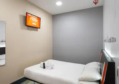 a room with a bed and a tv on the wall at easyHotel Ipswich in Ipswich