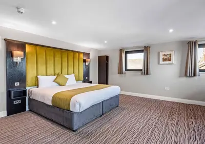 a large bedroom with a large bed in it at St Nicholas Hotel Colchester in Colchester
