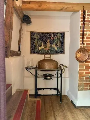 a room with a table with a pot on a wall at Swan Hotel in Harleston