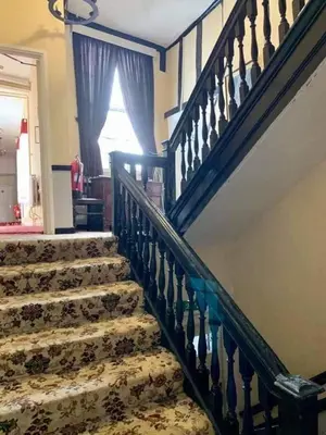 a staircase in a house with a stair case at Swan Hotel in Harleston