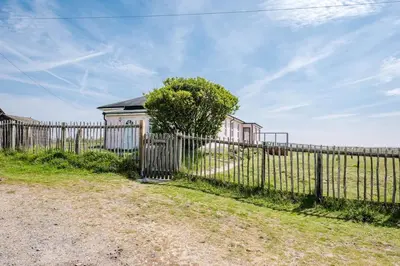 a fence in front of a house at Fairhaven, Thorpeness in Thorpeness