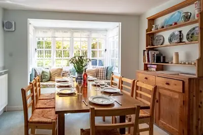 a dining room with a wooden table and chairs at 7 Whinlands in Thorpeness