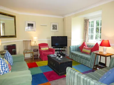 a living room with couches and a tv at 7 Whinlands in Thorpeness