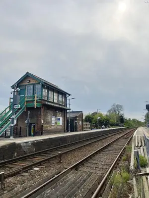 a train station with a building next to the tracks at The Courtyard in Newmarket