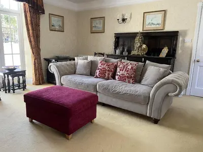 a living room with a couch and a ottoman at The Courtyard in Newmarket