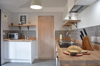 a kitchen with a sink and a counter top at Milk Parlour in Spexhall