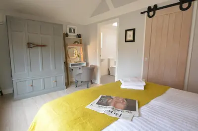 a bedroom with a newspaper on top of a bed at Milk Parlour in Spexhall