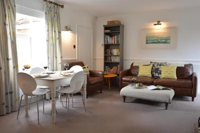 a living room with a table and chairs and a couch at Rookyards in Spexhall