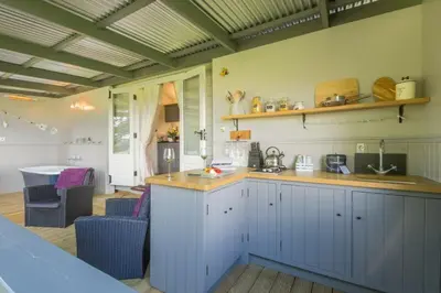 a kitchen with white cabinets and a counter top at Thompson Hall Retreat in Thompson