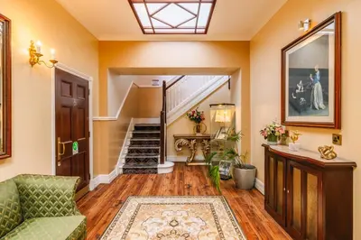 a living room with a couch and a staircase at Muthu Belstead Brook Hotel in Ipswich