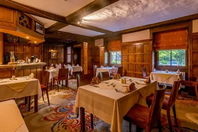 a restaurant with tables and chairs in a room at Muthu Belstead Brook Hotel in Ipswich