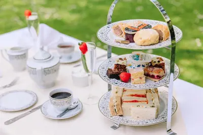 a table with plates of pastries and cups of coffee at Muthu Belstead Brook Hotel in Ipswich