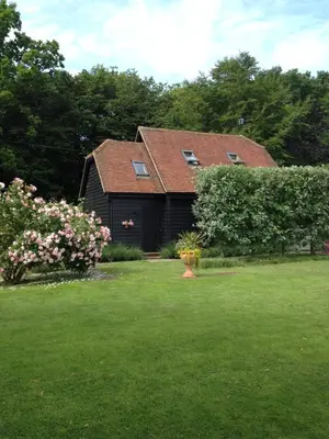 a house with a green yard with a house at Wellrose Barn in Hertford