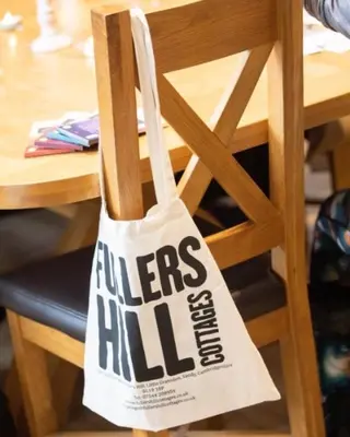 a bag sitting on top of a wooden chair at Fullers Hill Cottages in Little Grandsen