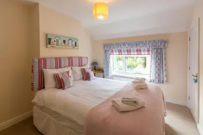 a bedroom with a bed with towels on it at 18 Pilgrim’s Way in Thorpeness