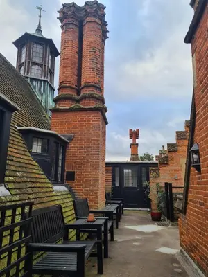 a group of benches sitting next to a brick building at Spacious Country House Apartment in Newmarket