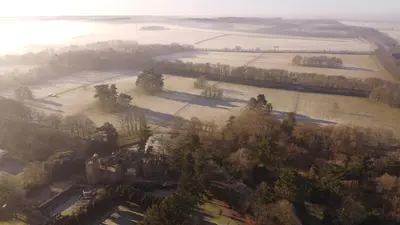 an aerial view of a castle in a field at Spacious Country House Apartment in Newmarket