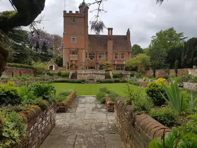 an old castle with a garden in front of it at Spacious Country House Apartment in Newmarket