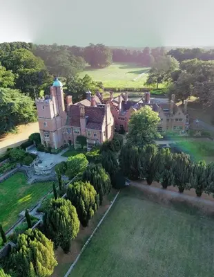 an aerial view of a large mansion with trees at Spacious Country House Apartment in Newmarket