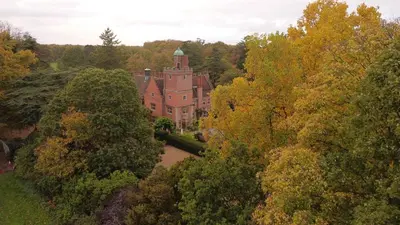 an aerial view of a building in the midst of trees at Spacious Country House Apartment in Newmarket
