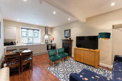 a living room with a tv and a kitchen at Beautiful Country House Apartment in Newmarket