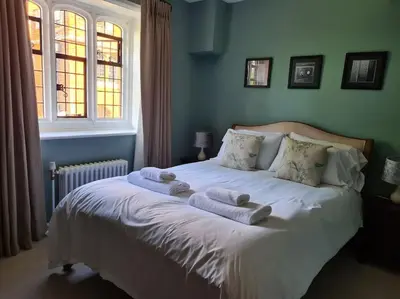 a bedroom with a bed with towels on it at Beautiful Country House Apartment in Newmarket