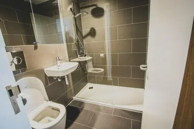 a small bathroom with a toilet and a sink at Newnham College - University of Cambridge in Cambridge