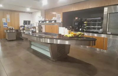 a large kitchen with a counter in a restaurant at Newnham College - University of Cambridge in Cambridge