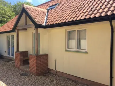 a detached house with a red roof at Blyth Green Stable in Long Stratton