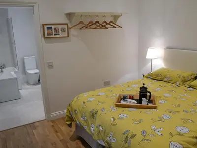 a bedroom with a bed with a tray on it at Blyth Green Stable in Long Stratton