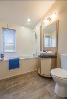 a bathroom with a toilet and a sink and a tub at Mikanda Lodge in Clacton-on-Sea