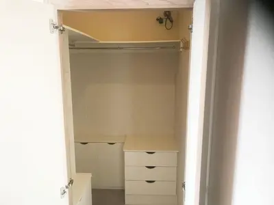 a closet with a white cabinet and a drawer at Mikanda Lodge in Clacton-on-Sea