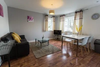 a living room with a couch and a table at Meridian Apartment Suites in Southend-on-Sea