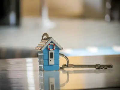 a small toy house with a key on a table at 14 Market Cross Place - Beachfront location with lovely sea views - Aldeburgh Coastal Cottages in Aldeburgh