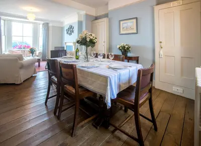 a dining room with a table and chairs at 14 Market Cross Place - Beachfront location with lovely sea views - Aldeburgh Coastal Cottages in Aldeburgh