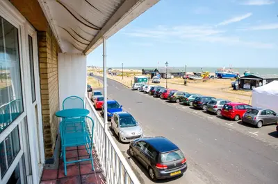 a balcony with cars parked on the side of a building at 14 Market Cross Place - Beachfront location with lovely sea views - Aldeburgh Coastal Cottages in Aldeburgh