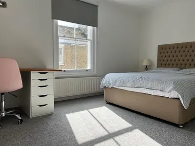 a bedroom with a bed and a desk and a window at 200m To Botanical Garden 3 Bedroom Victoria House in Cambridge