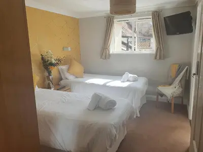a hotel room with two beds and a window at The Nags Head in Norwich