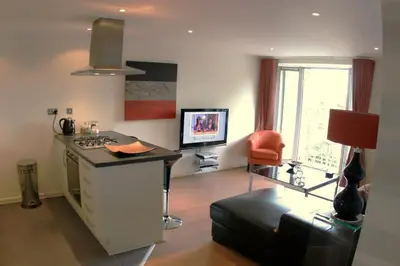 a living room with a desk and a chair at Chelmsford Serviced Apartments in Chelmsford