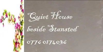 a sign for a guest house with flowers on it at Fully equipped Large 3 bedroom in Bishops Stortford