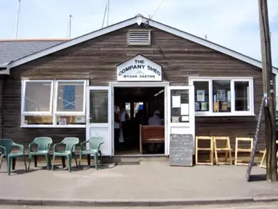 a building with chairs in front of a restaurant at The Mariners Suite in West Mersea