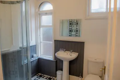 a bathroom with a sink and a toilet and a shower at Toothbrush Apartments - Central Ipswich - Fonnereau Road in Ipswich