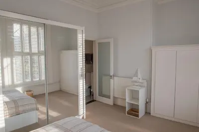 a white room with a bed and a mirror at Toothbrush Apartments - Central Ipswich - Fonnereau Road in Ipswich